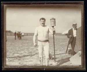 Fred Winters, competidor en el concurso de pesas en los Juegos Olímpicos de 1904 posando con pesas